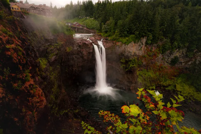 Snoqualmie Falls and the lodge above it seen from the canyon rim with autumn colour